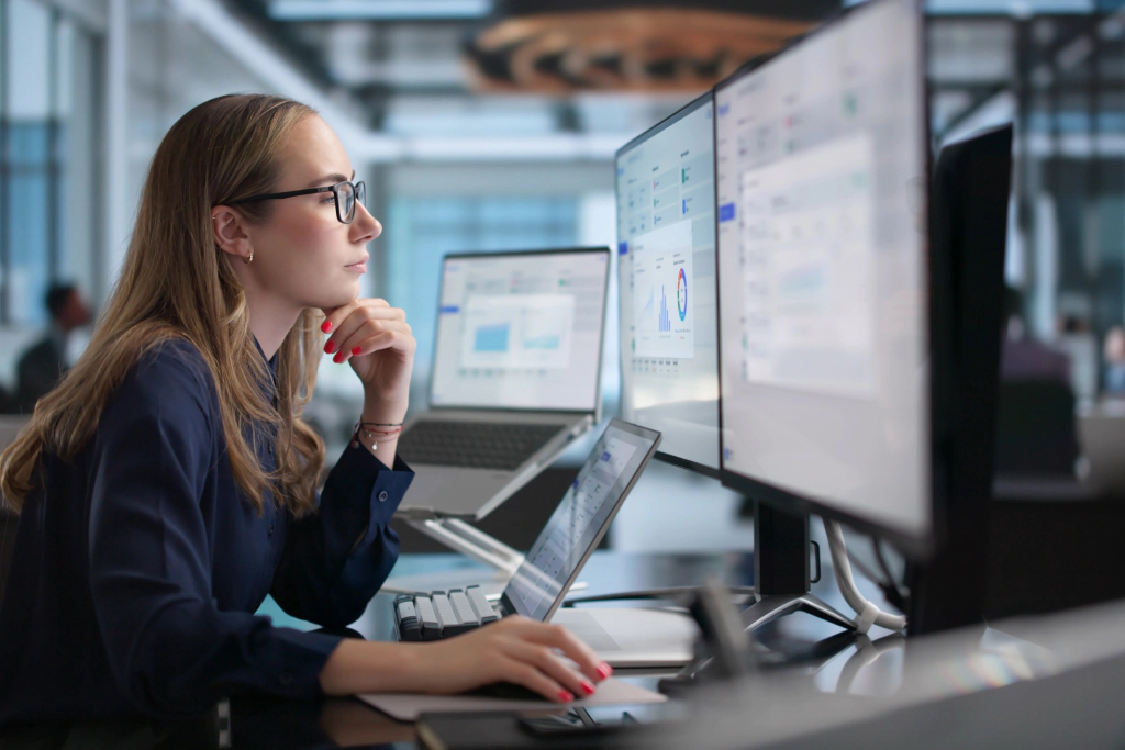 Analyst reviewing data across multiple screens.